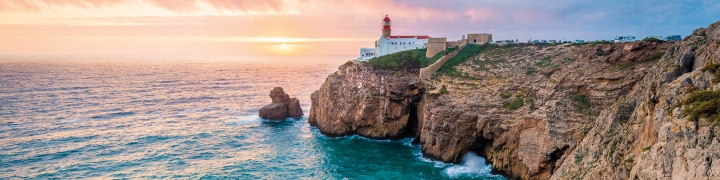 Coastal view with lighthouse in the distance in Lisbon, Portugal