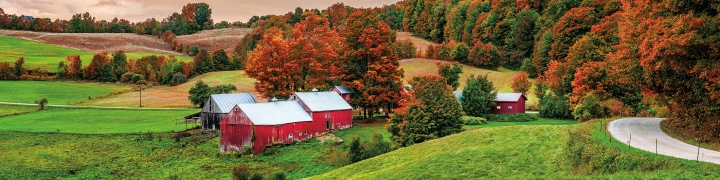 Scenic fall foliage scene with red barn in Vermont