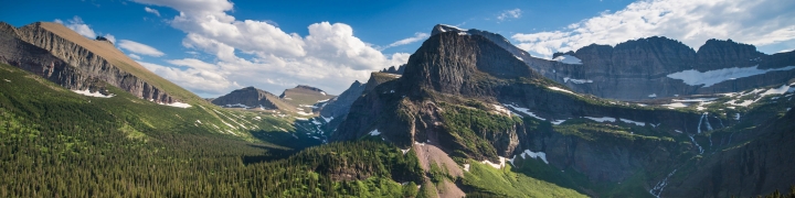 Scenic view of a lush mountain valley and lake at Glacier National Park