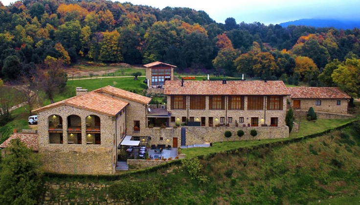 stone hotel aerial exterior with autumn trees in the background