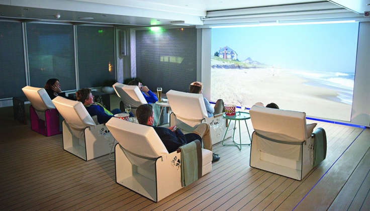 cinema room with six chairs and people