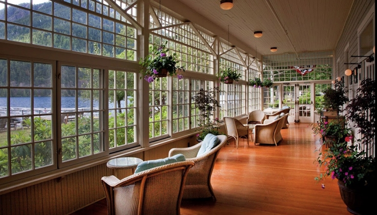 Lake Crescent Lodge porch looking onto a lake with hill in background