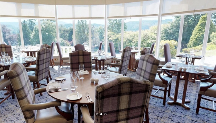 hotel dining area with large windows looking out onto valley forest