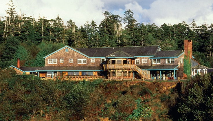 hotel lodge exterior with pine trees in the background