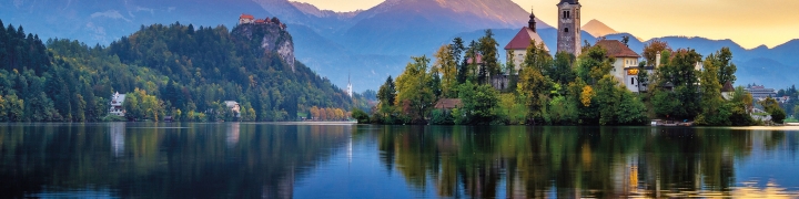 Sunrise over lake Bled in Slovenia with mountains in the background