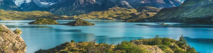 Scenic view of a blue lake with a snowy mountains background of Torres del Paine in Chile, Patagonia