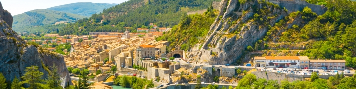 View of Sisteron and village along a river in the Provence-Alpes-Côte d'Azur region in France
