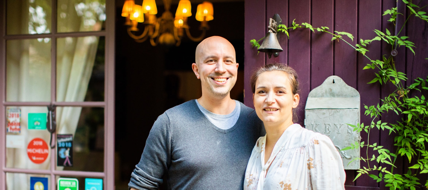 Couple standing in front of a door